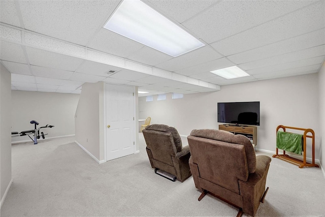 living room featuring light colored carpet and a drop ceiling