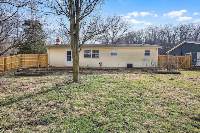 rear view of house with a lawn