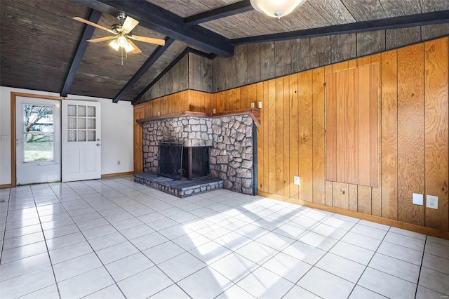 unfurnished living room featuring light tile patterned flooring, a fireplace, lofted ceiling with beams, and wood walls