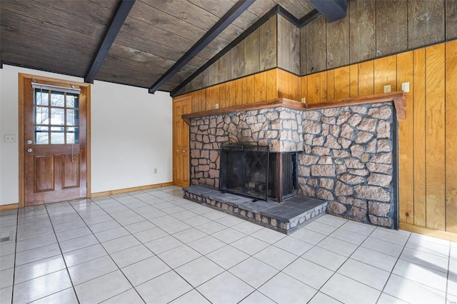 unfurnished living room featuring tile patterned flooring, vaulted ceiling with beams, and wood walls