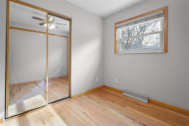 unfurnished bedroom with a closet, ceiling fan, and light wood-type flooring