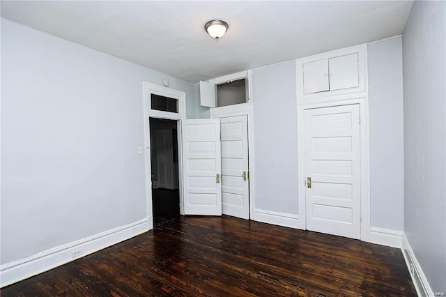 unfurnished bedroom featuring dark hardwood / wood-style floors