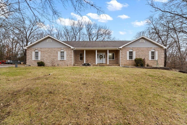 single story home featuring a front yard and covered porch