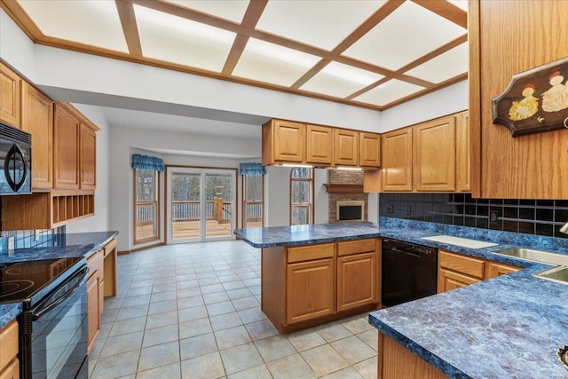 kitchen featuring light tile patterned flooring, sink, black appliances, kitchen peninsula, and backsplash