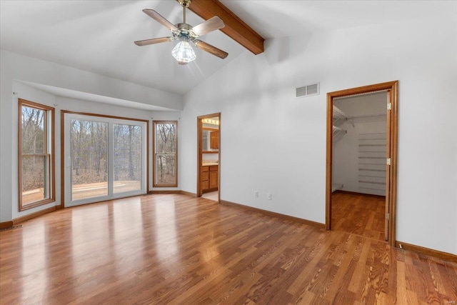 interior space with lofted ceiling with beams, ceiling fan, and light hardwood / wood-style floors