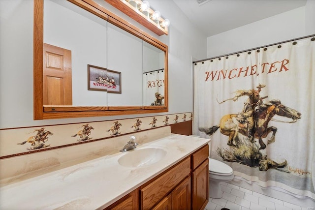 bathroom featuring vanity, toilet, and tile patterned flooring