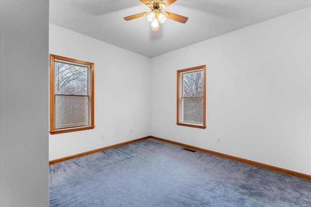 unfurnished room featuring ceiling fan and carpet flooring