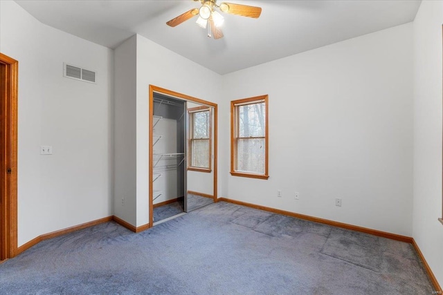 unfurnished bedroom with light carpet, a closet, and ceiling fan