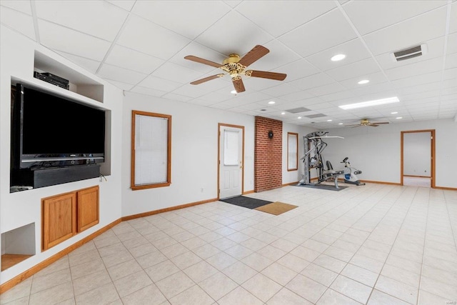 exercise area with a drop ceiling and ceiling fan