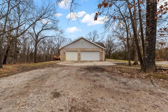 view of side of home with a garage and a deck