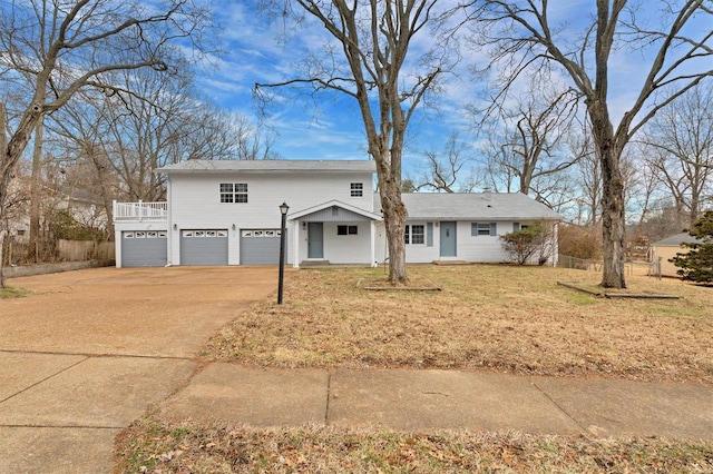 view of front of property with a garage and a front lawn