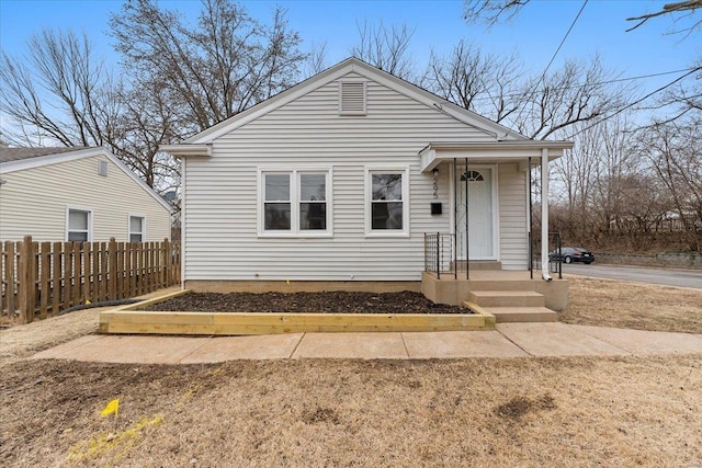 bungalow-style home with fence