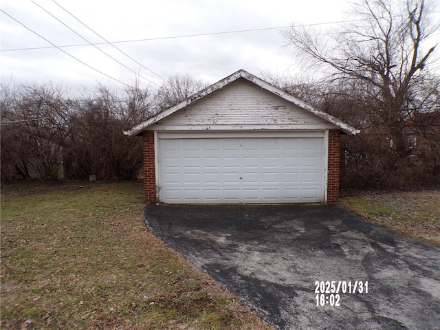 garage featuring a lawn