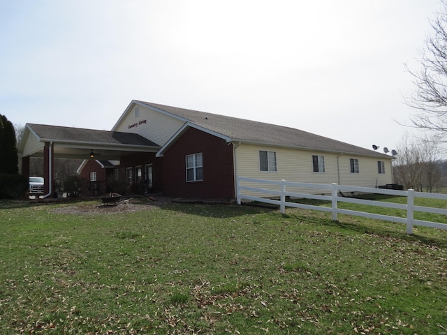 view of side of property with a yard