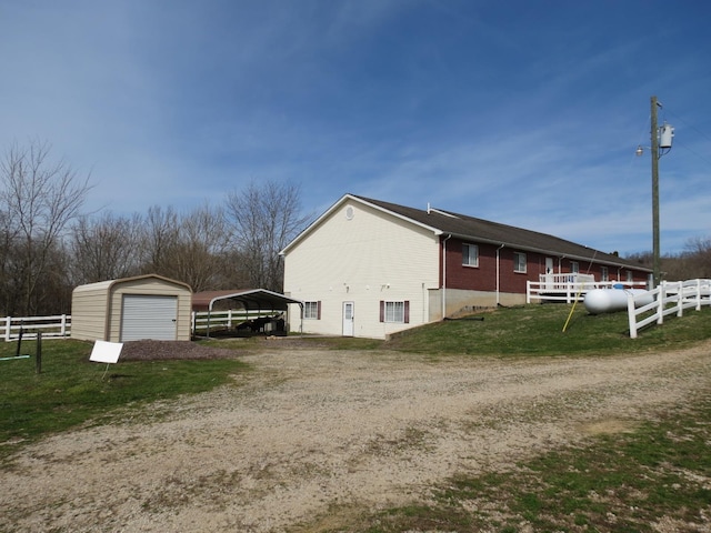 view of side of home featuring a carport and a yard