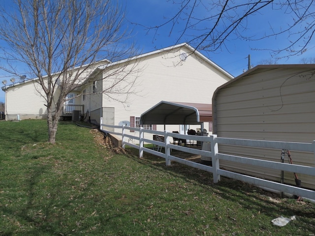 view of home's exterior with a carport and a yard