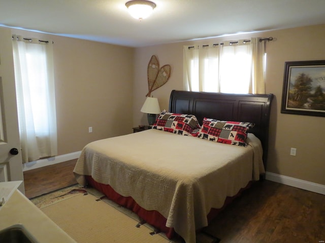 bedroom with dark hardwood / wood-style floors