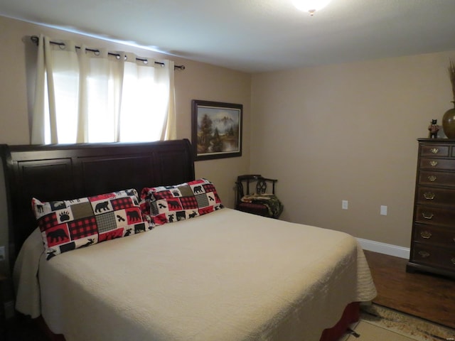 bedroom with dark wood-type flooring