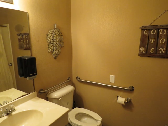 bathroom with toilet and sink