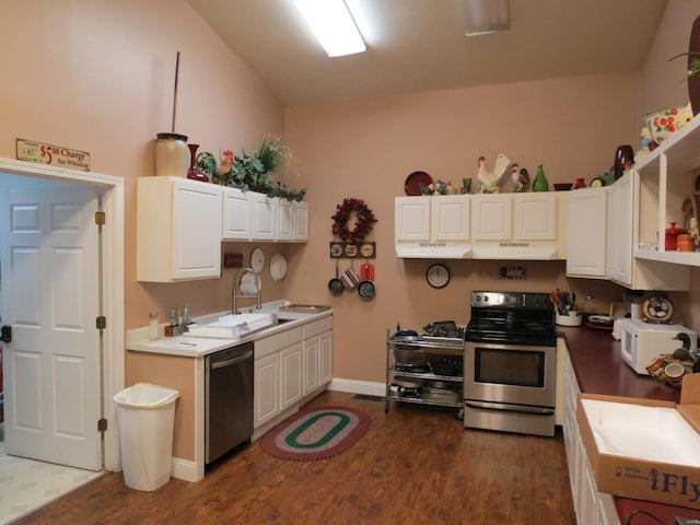 kitchen featuring dark hardwood / wood-style flooring, sink, stainless steel appliances, and white cabinets