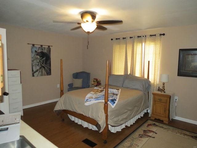 bedroom with dark wood-type flooring and ceiling fan