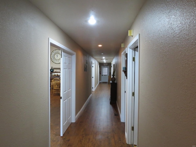 corridor with dark hardwood / wood-style floors