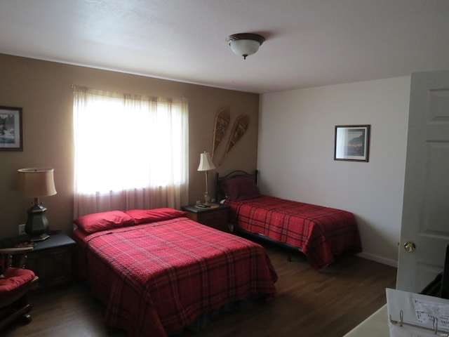 bedroom with dark hardwood / wood-style flooring