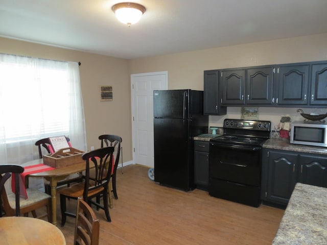 kitchen featuring light hardwood / wood-style flooring and black appliances