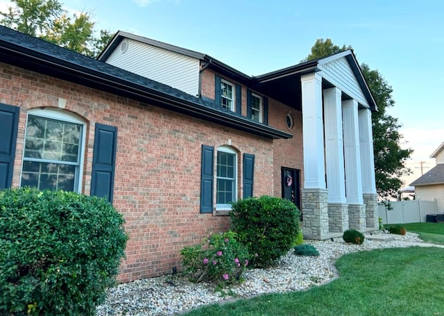 view of side of property with a lawn