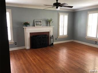 unfurnished living room featuring wood-type flooring, ceiling fan, and crown molding