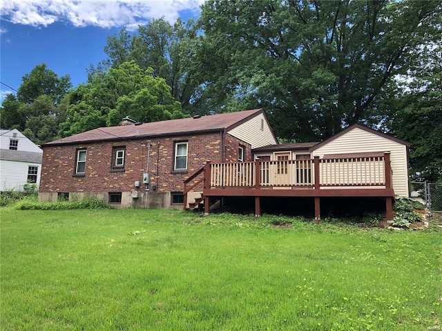 rear view of house with a deck and a lawn