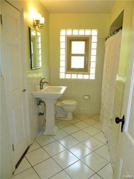 bathroom with tile walls, tile patterned floors, and toilet