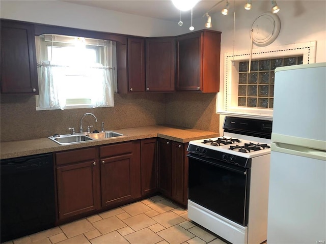 kitchen with tasteful backsplash, black dishwasher, sink, white fridge, and gas range