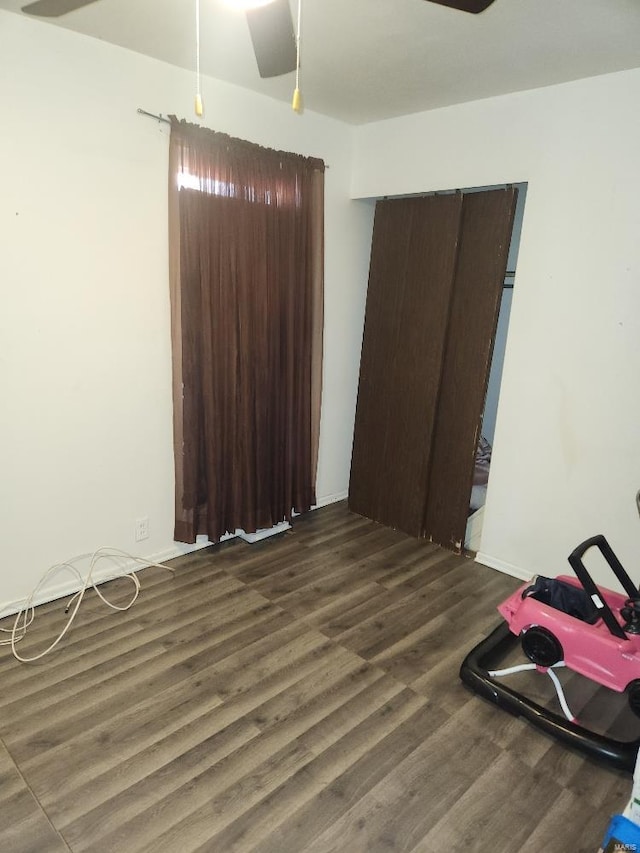 bedroom with dark hardwood / wood-style floors and ceiling fan