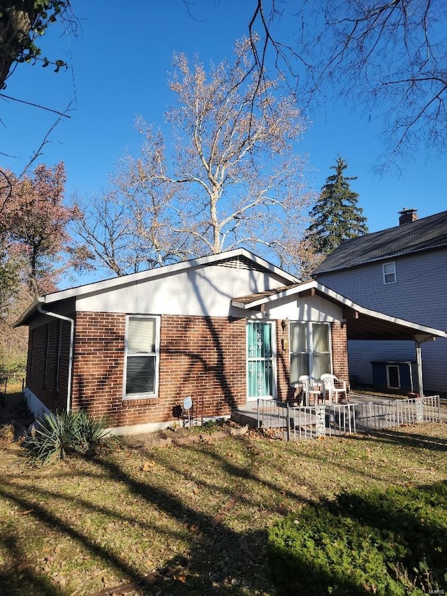 back of property featuring a yard and a patio area