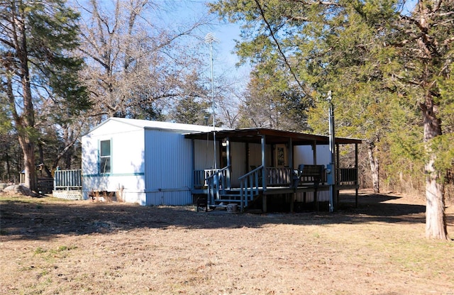 view of front of home featuring covered porch and a front yard