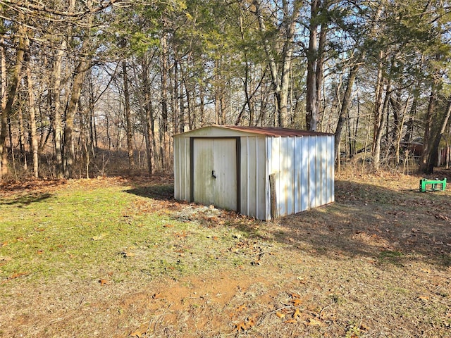 view of outbuilding featuring a lawn