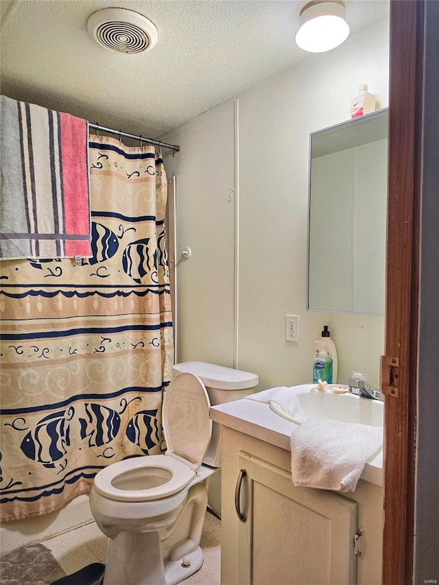 bathroom with vanity, a shower with curtain, toilet, and a textured ceiling