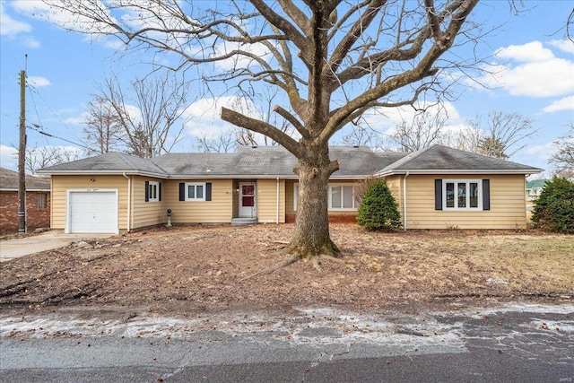 single story home with driveway and an attached garage