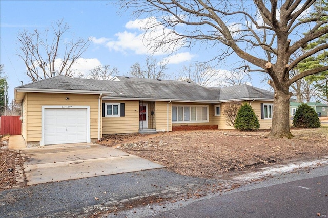 ranch-style house featuring a garage and driveway