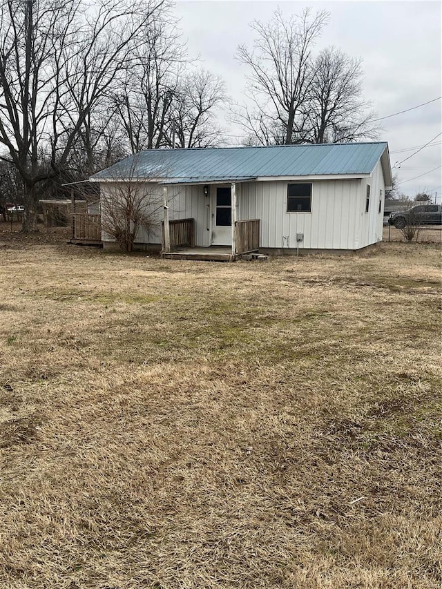 rear view of property featuring a yard