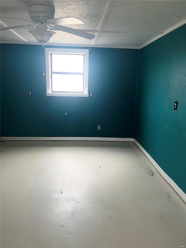 spare room with concrete floors and ceiling fan