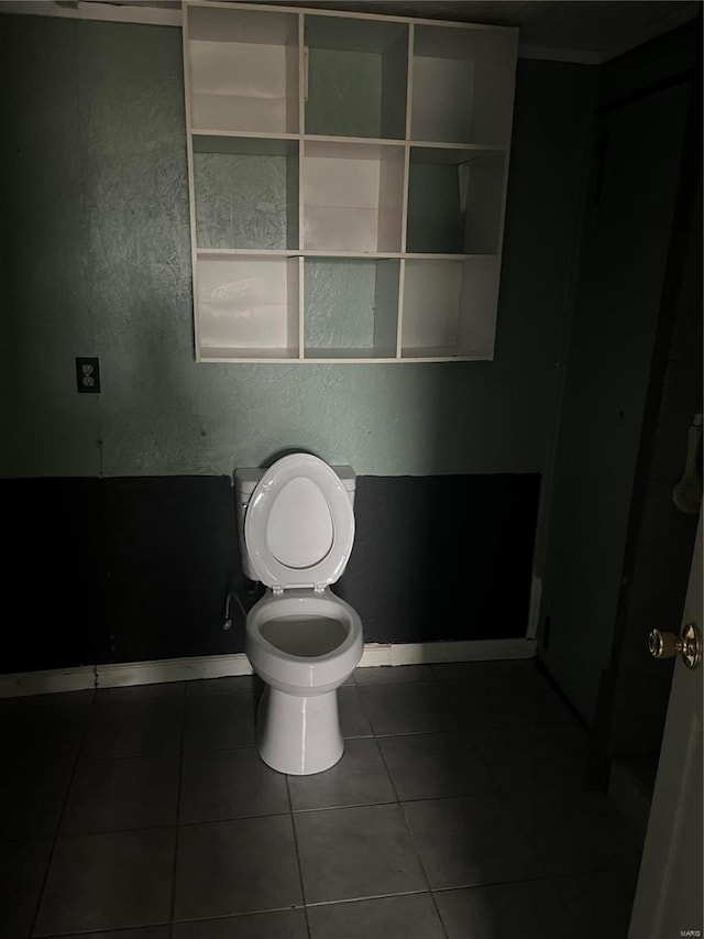 bathroom with tile patterned flooring and toilet