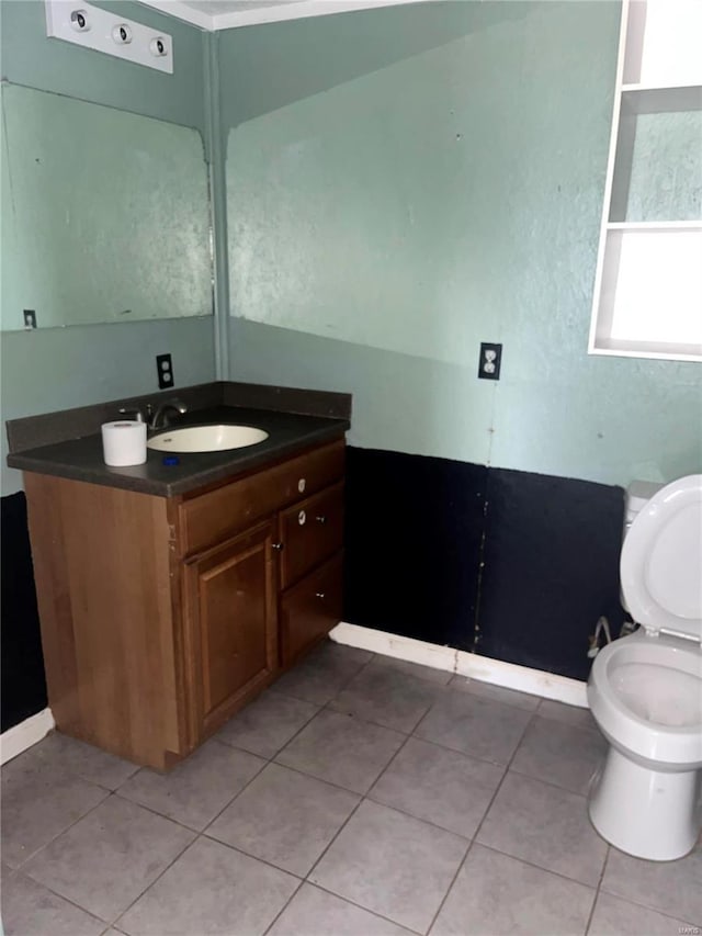 bathroom featuring vanity, tile patterned floors, and toilet