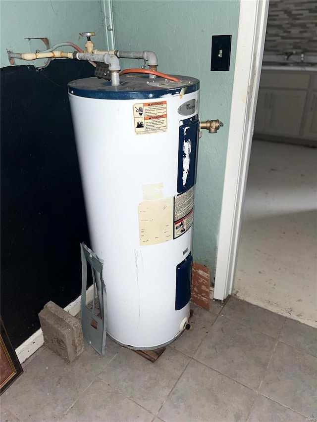 utility room with sink and water heater