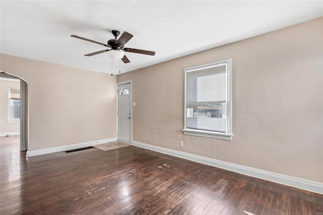 spare room featuring dark hardwood / wood-style flooring and ceiling fan