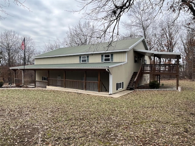 back of house with a wooden deck and a yard