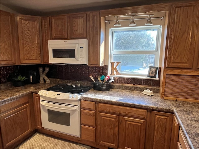 kitchen featuring tasteful backsplash and white appliances