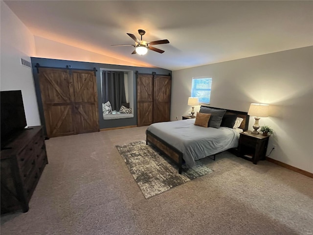 carpeted bedroom with lofted ceiling, a barn door, and ceiling fan