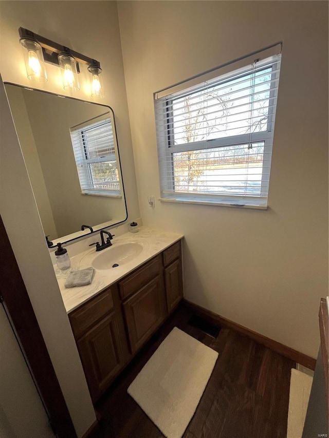 bathroom with hardwood / wood-style flooring and vanity